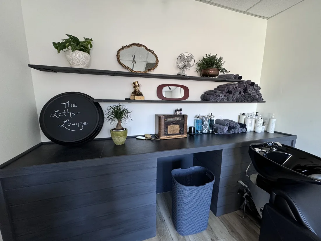 The Lather Lounge wash station with rolled towels and plants