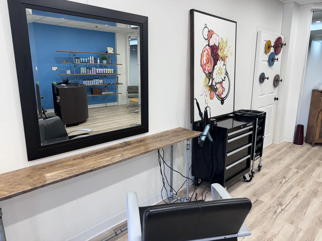 A styling station with a large mirror and colour samples