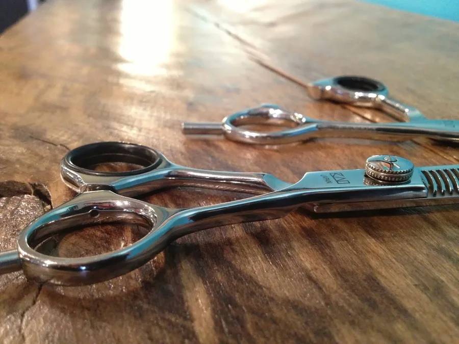 Stylist scissors on a wooden table